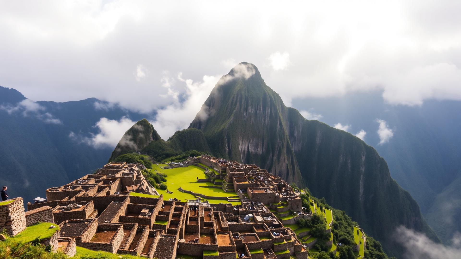 Machu Picchu's stone terraces below Huayna Picchu peak with morning mist in the Andes